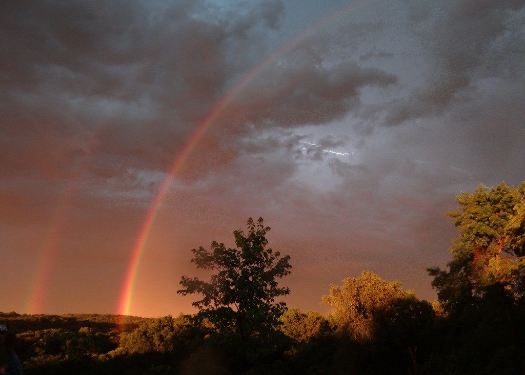 sky with rainbow and lightning