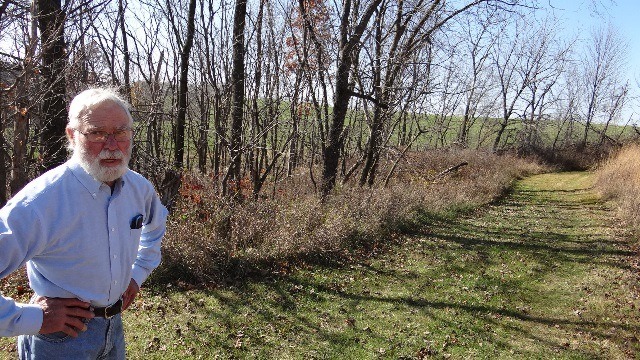 Steve Beaumont stands in front of the timber area of his donated property.