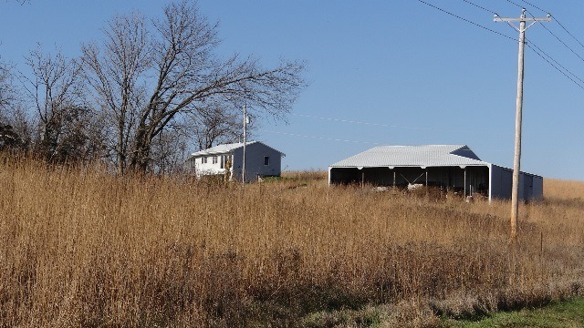Steve Beaumont's land, with his home and an additional outbuilding in the background.
